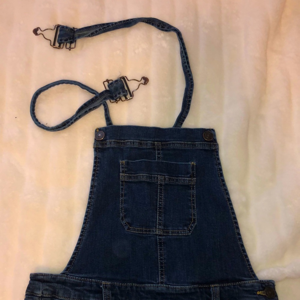 Dark denim overalls with button clasps